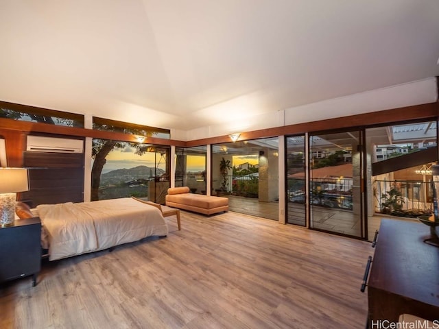 bedroom with hardwood / wood-style floors, access to outside, a wall mounted AC, and lofted ceiling