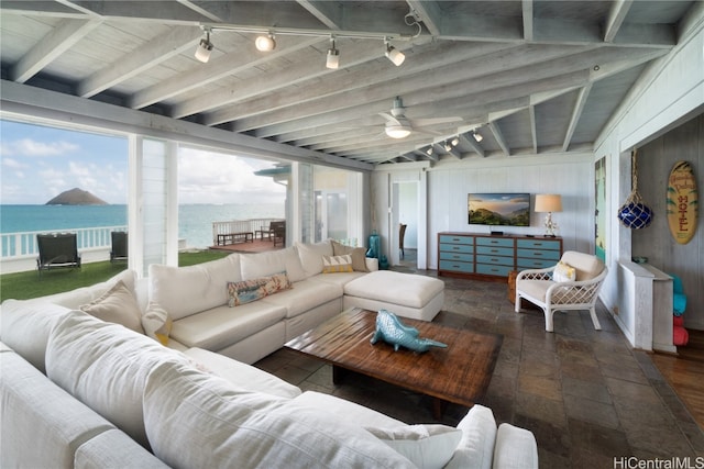 interior space with wooden ceiling, lofted ceiling with beams, rail lighting, a water view, and ceiling fan