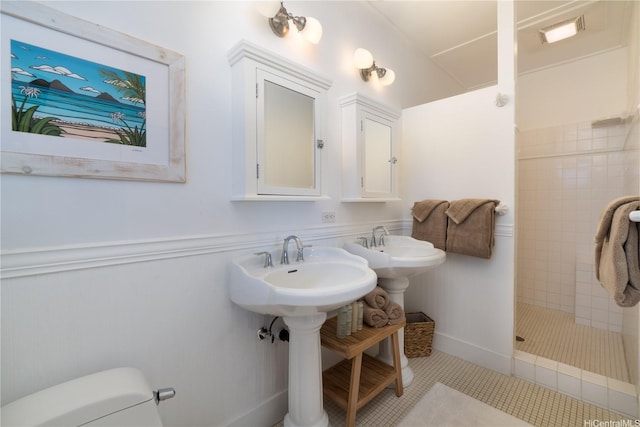 1276 Mokulua Dr, Kailua, HI 96734 - bathroom featuring toilet, a shower stall, a wainscoted wall, and tile patterned flooring