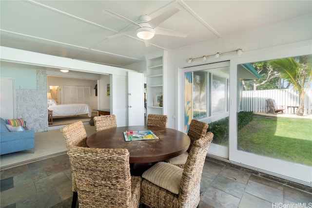 sunroom / solarium featuring ceiling fan