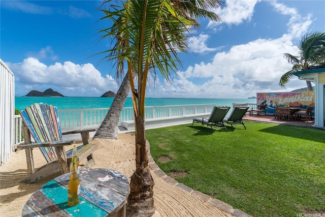1276 Mokulua Dr, Kailua, HI 96734 - view of green lawn with outdoor dining area, a water view, and a patio area