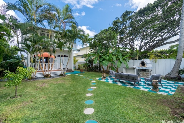 view of yard featuring an outdoor living space with a fireplace and a patio