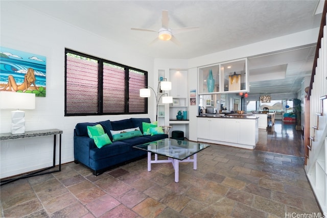 living room with dark wood-type flooring and ceiling fan