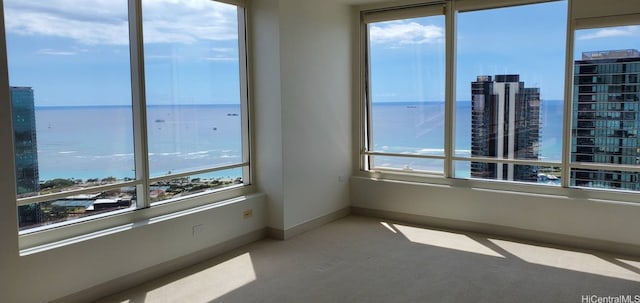 spare room featuring a water view