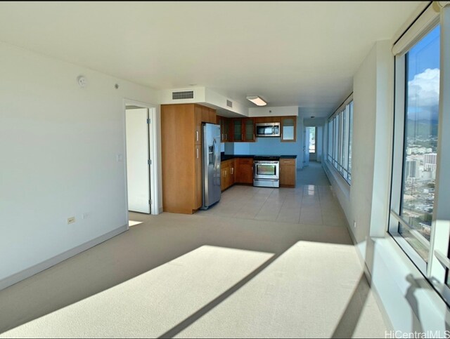 kitchen with stainless steel appliances and light tile patterned floors