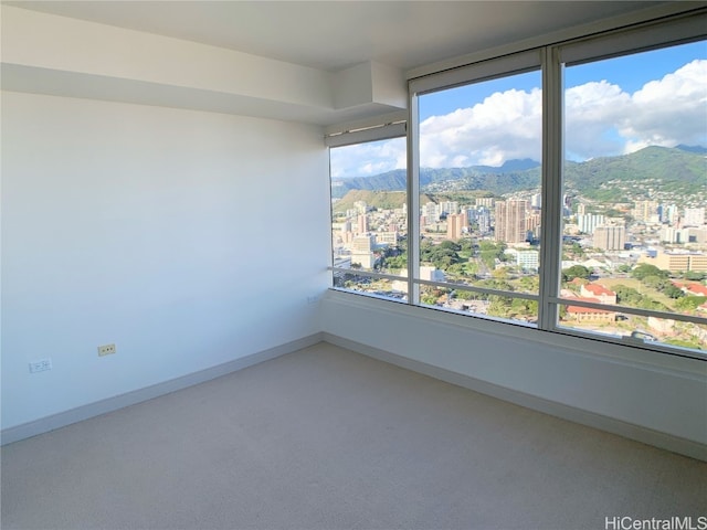 carpeted spare room with a mountain view