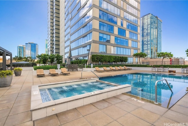 view of pool with a patio area and a community hot tub