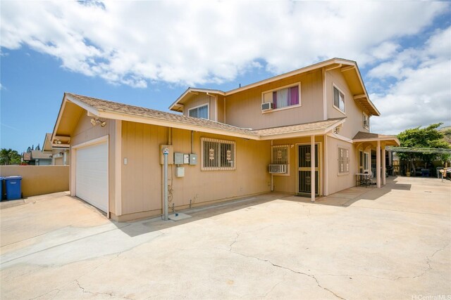 86-196 Moekolu St, Waianae, HI 96792 - back of house with a shingled roof, cooling unit, an attached garage, and concrete driveway