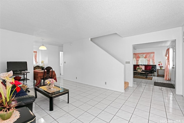 tiled living room featuring a textured ceiling