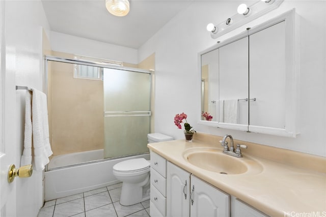 full bathroom featuring vanity, bath / shower combo with glass door, toilet, and tile patterned floors