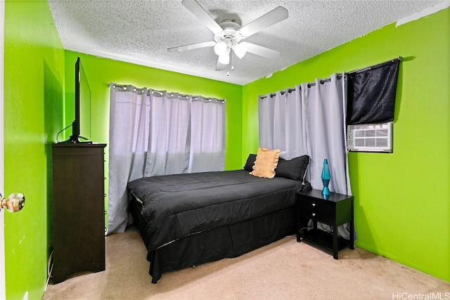 bedroom featuring a textured ceiling, cooling unit, light colored carpet, and ceiling fan