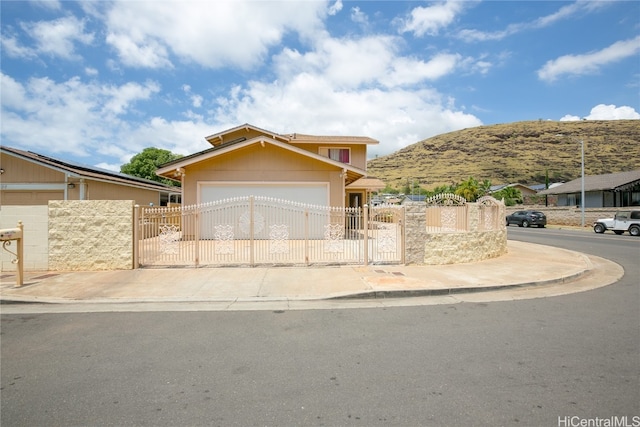 view of front of home with a garage and a mountain view