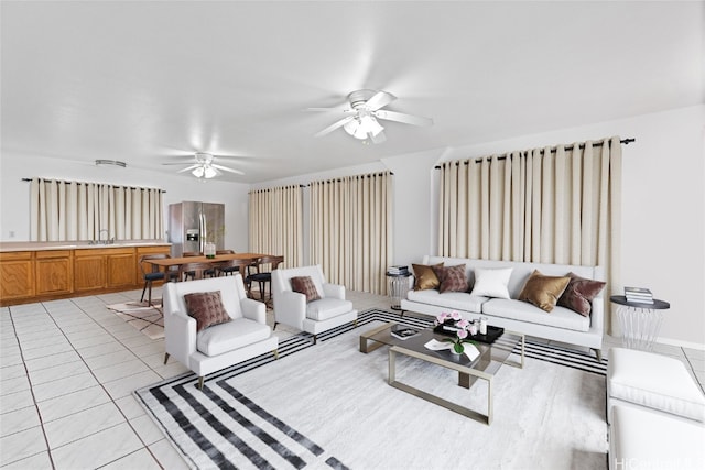 living room featuring sink, light tile patterned floors, and ceiling fan