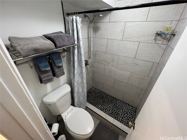 bathroom featuring toilet and walk in shower