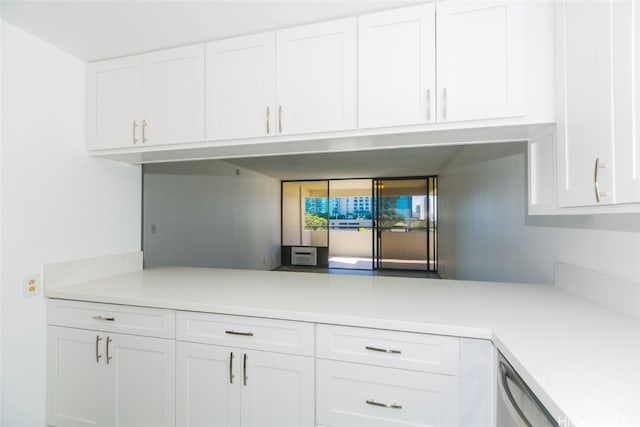 kitchen featuring dishwasher and white cabinets