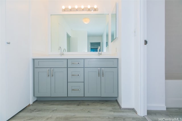 bathroom featuring vanity and hardwood / wood-style flooring