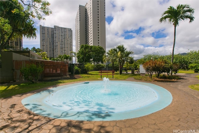 view of pool with a lawn