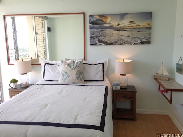 bedroom with wood-type flooring