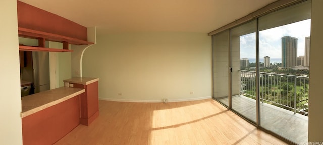 1925 Kalakaua Ave Unit 1902, Honolulu, HI 96815 - interior space featuring a view of city, wood finished floors, plenty of natural light, and baseboards