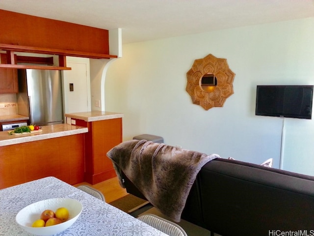 kitchen with stainless steel fridge and light hardwood / wood-style floors