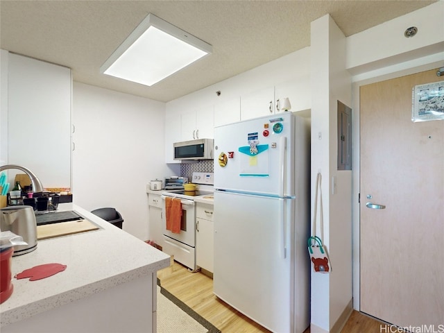 kitchen featuring light hardwood / wood-style flooring, electric panel, white cabinetry, white appliances, and tasteful backsplash