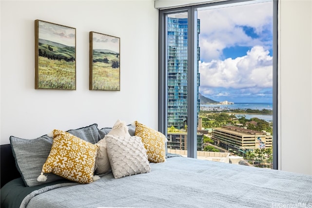 bedroom featuring access to outside and a water view