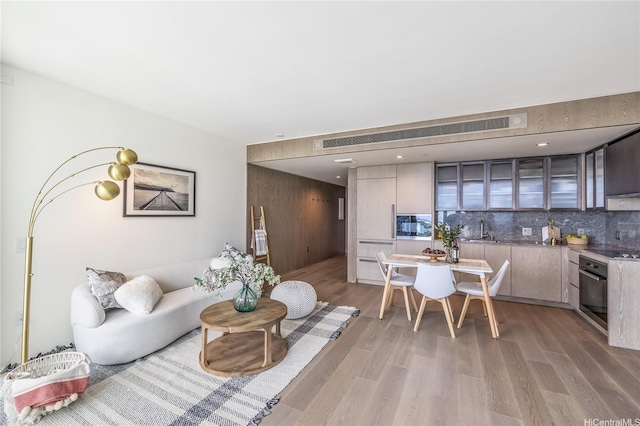living room with light wood-type flooring and visible vents