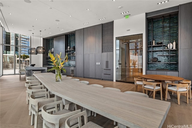 dining area featuring light hardwood / wood-style floors and floor to ceiling windows