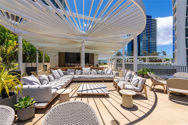 view of patio / terrace featuring fence, an outdoor hangout area, and outdoor dining area