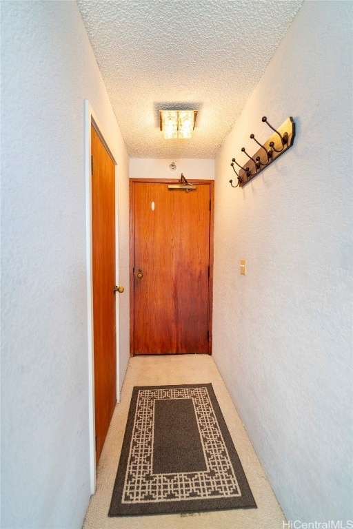 corridor featuring a textured ceiling