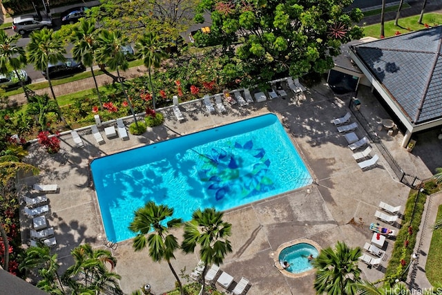 view of pool with a hot tub and a patio