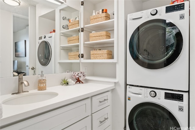 washroom with sink and stacked washer and dryer