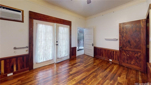 interior space featuring a wall unit AC, ornamental molding, dark wood-type flooring, and wooden walls