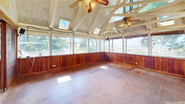 unfurnished sunroom with vaulted ceiling with skylight and ceiling fan