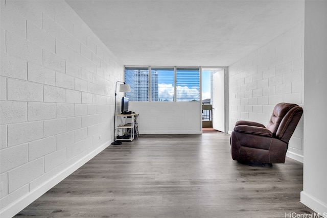 living area featuring floor to ceiling windows and dark hardwood / wood-style floors