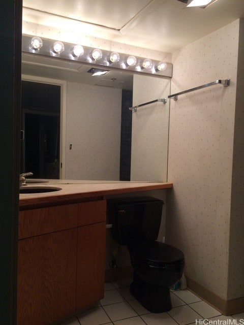 bathroom featuring toilet, vanity, and tile patterned floors