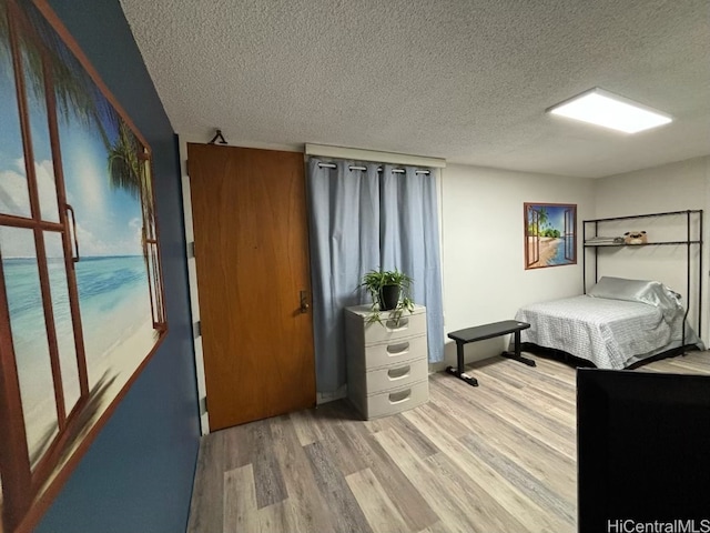 bedroom featuring hardwood / wood-style floors and a textured ceiling