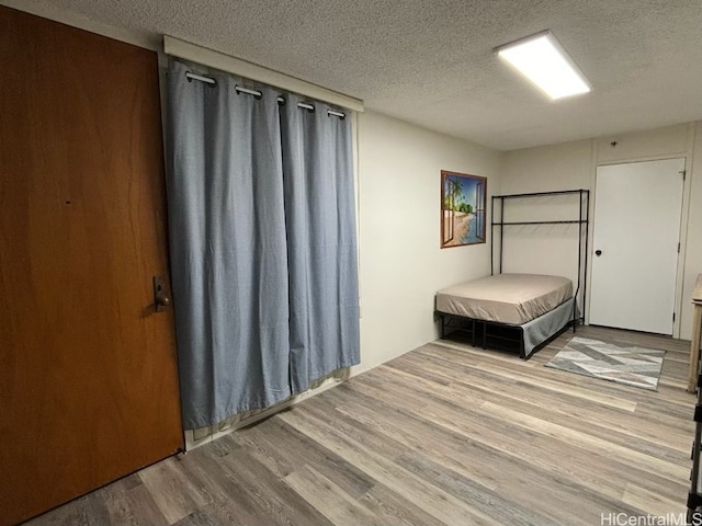 unfurnished bedroom with hardwood / wood-style flooring and a textured ceiling