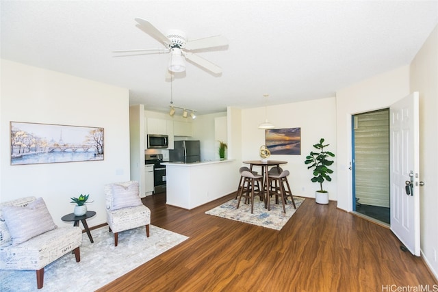 interior space with dark wood-type flooring and ceiling fan