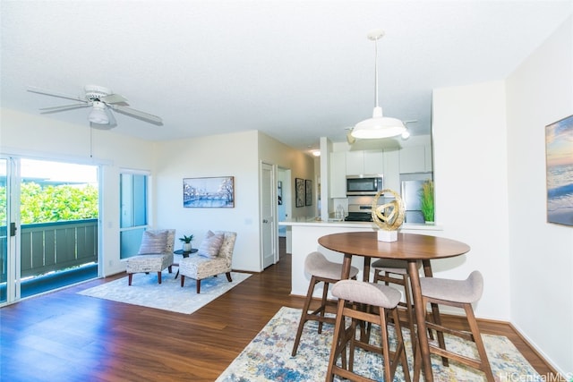 dining room featuring ceiling fan and dark hardwood / wood-style floors