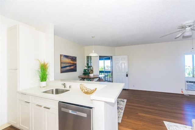 kitchen featuring dishwasher, kitchen peninsula, decorative light fixtures, white cabinetry, and dark hardwood / wood-style flooring