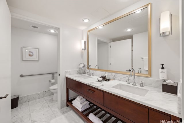 bathroom featuring vanity and toilet