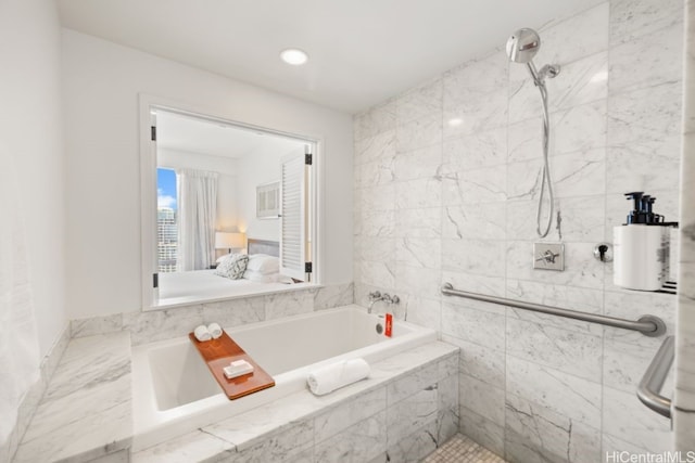 bathroom featuring separate shower and tub