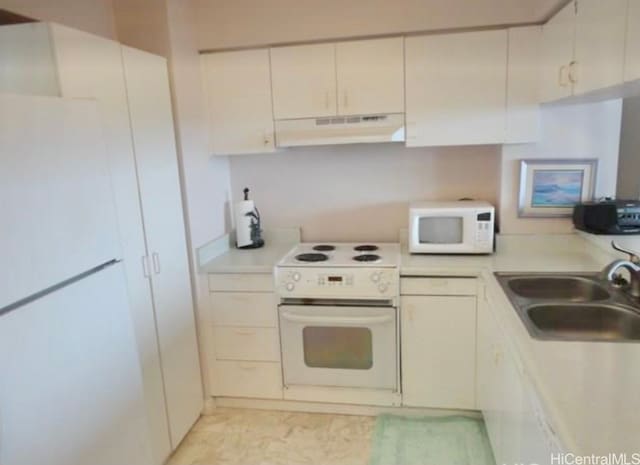 kitchen featuring white cabinetry, sink, and white appliances