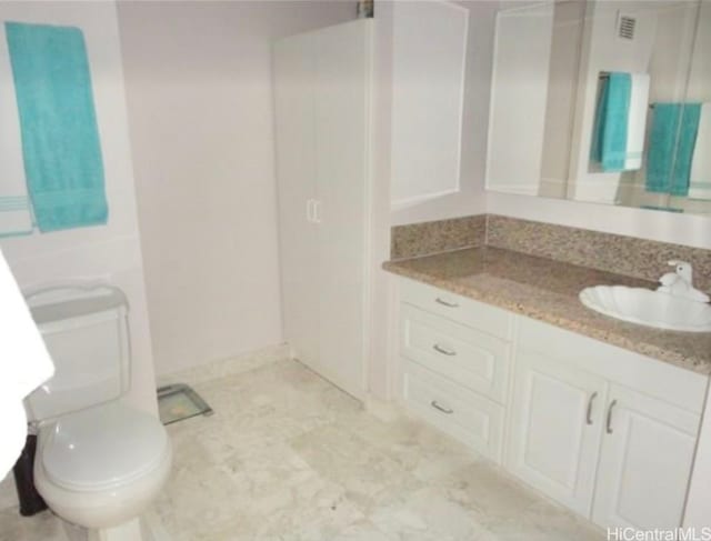 bathroom featuring toilet and vanity