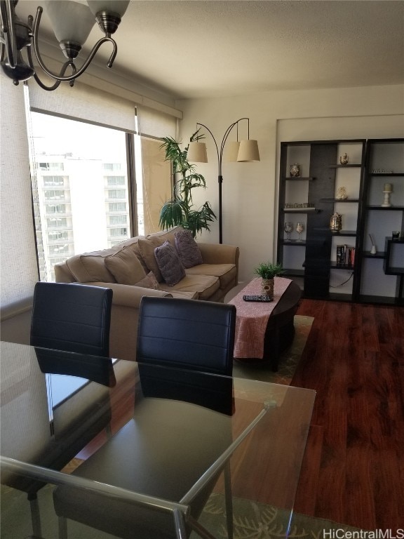 living room featuring hardwood / wood-style flooring and a chandelier