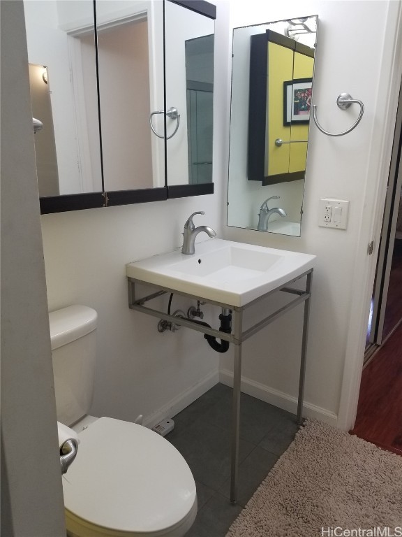 bathroom with toilet and tile patterned floors