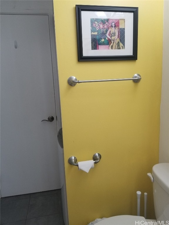 bathroom with toilet and tile patterned floors