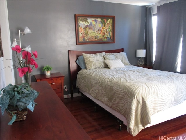 bedroom with dark hardwood / wood-style floors