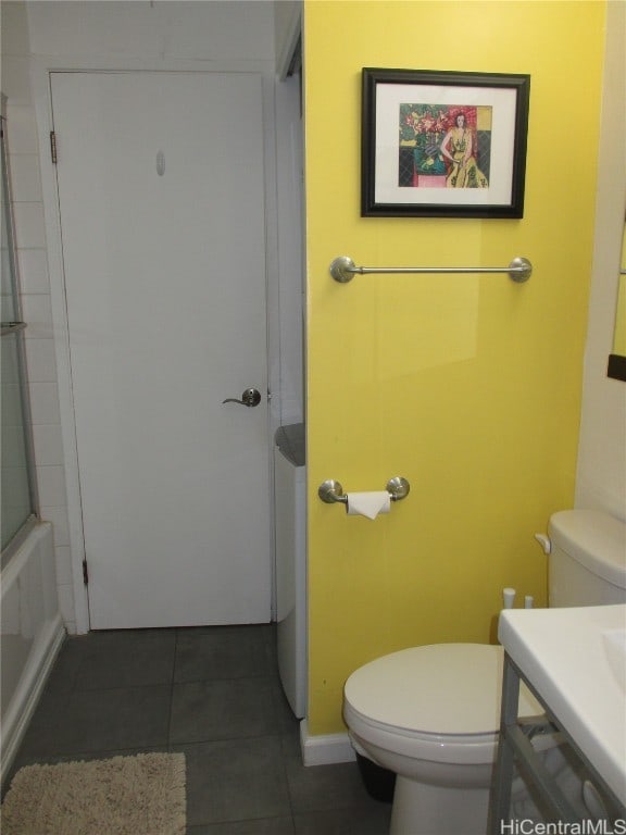 full bathroom featuring vanity, toilet, tile patterned floors, and enclosed tub / shower combo